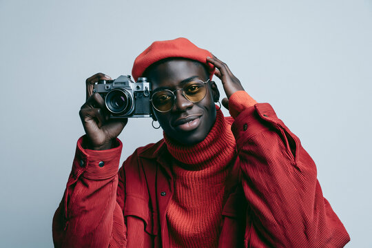 Stylish Black Photographer in Red Holding Vintage Camera