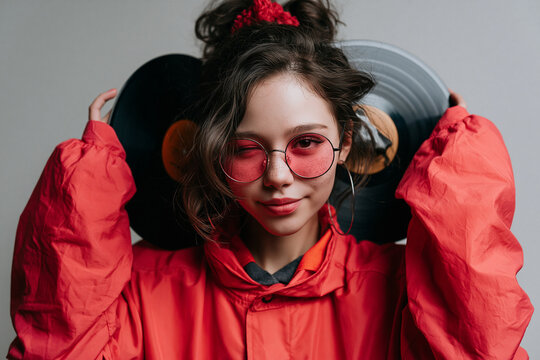 Retro Young Woman Holding Vinyl Records and Winking