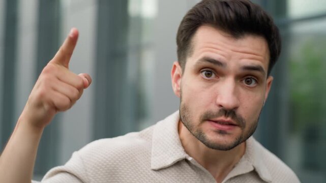 Close up angry emotional annoyed Caucasian business man looking at camera talking irritated negative male guy businessman professional worker talk annoy feeling stress dissatisfied speaking in city