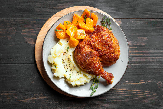 Autumn meal: chicken quarter with glazed pumpkin and mashed potato