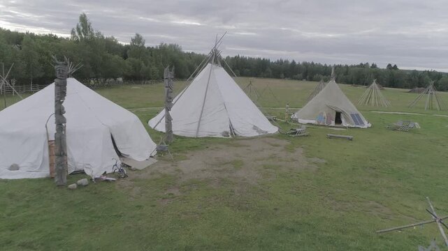 Low smooth forward flight past tipis and poles, D-Log