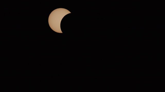 Close up timelapse of the annular solar eclipse in 2026 showcasing the sun partially covered by the moon cinematic quality captivating scenes atmospheric lighting