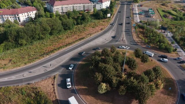 Wooded roundabout in Le Plessis Robinson during a diagonal left drone flight.