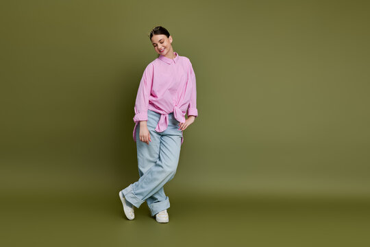 Brunette girl flaunts her style in a pink shirt and wide-leg jeans