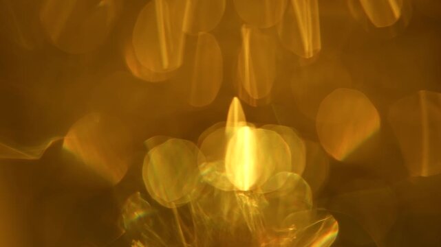 Blurred, defocused background with golden refractions and glowing bokeh. Concept optical abstraction for design, overlay, ads, websites, banners, magazines and presentations.