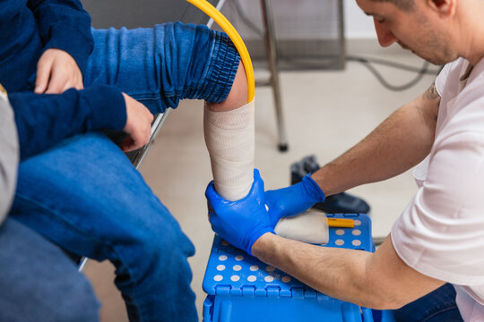 Orthopedic technician measuring child's leg for an orthosis