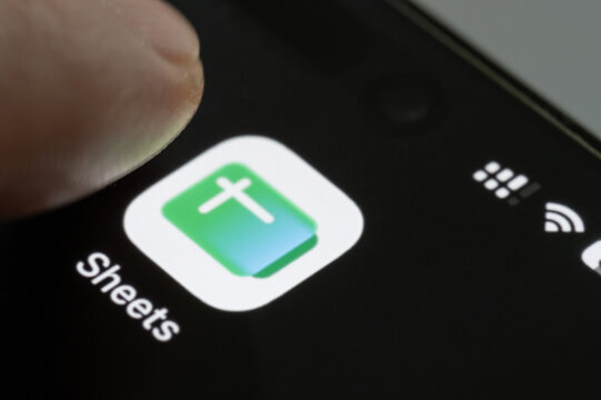 Finger press google sheets app icon