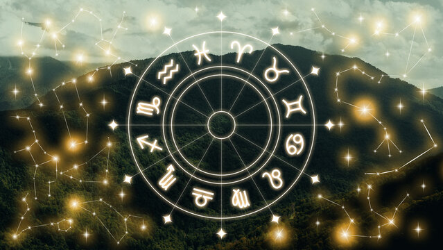Astrology zodiac signs display with constellations over a mountain background during daytime