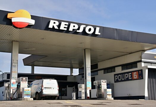 Repsol gas station with a white van parked under the canopy