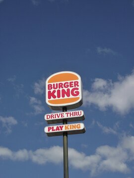 Burger King sign standing tall against a blue sky