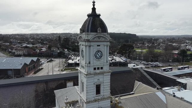 Aerial view orbiting historic town hall clock tower