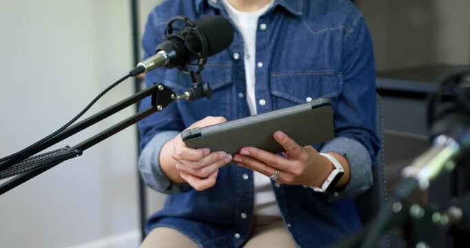 On start studio podcaster is bringing tablet up, rotating and steadying it near microphone to speak