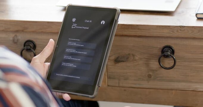 Right thumb is starting scroll, user is adjusting tablet and reading replies at desk with laptop