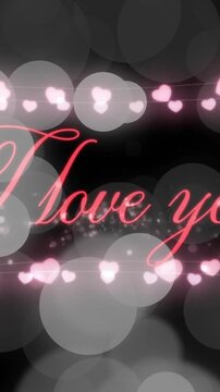 Animation of i love you text over hearts and spots