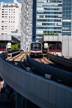 Vienna, Austria - August 14, 2026: U-Bahn U1 subway train departing Kaisermuehlen station against the backdrop of modern high-rise architecture in Donau City.