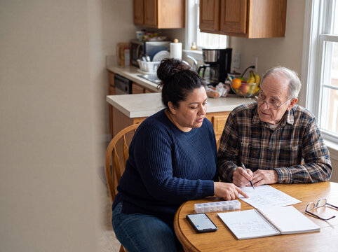 Daughter Helping Elderly Father Prepare for Doctor's Appointment