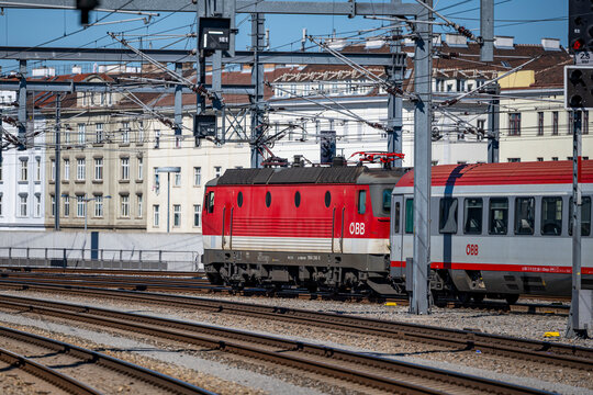 Vienna, Austria - August 14, 2026: Passenger train entering the railway station area along curved tracks.