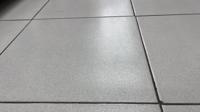 Extreme close up of minimalist grey ceramic floor tiles texture