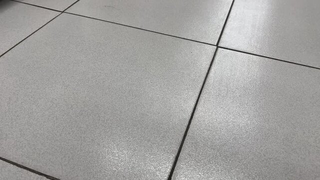 Bright glare and light reflection on minimalist ceramic floor tiles