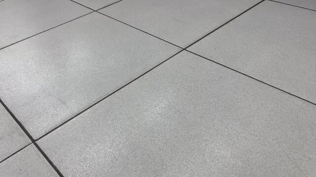 High angle shot of minimalist grey ceramic floor tiles background
