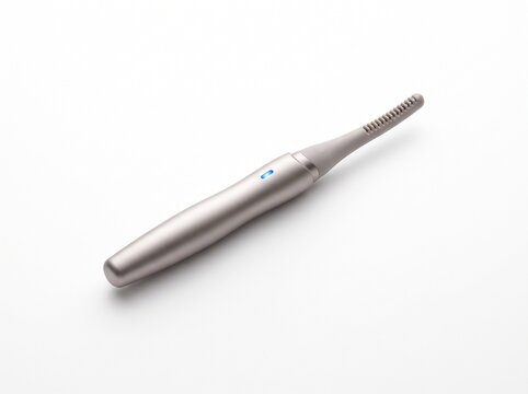 Modern electric toothbrush with sleek metallic design on white background.