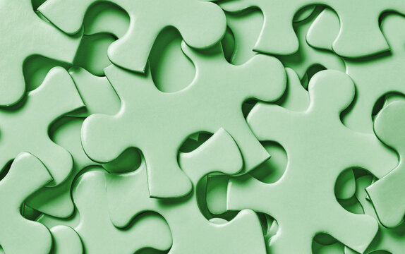 Green jigsaw puzzle pieces close up