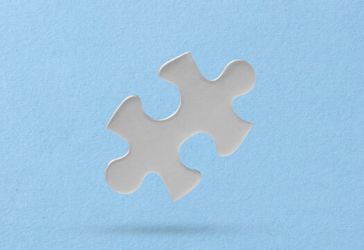 White puzzle piece on blue background