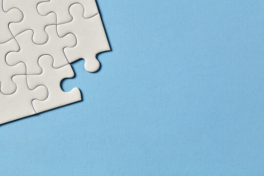 Puzzle corner on blue background with copy space
