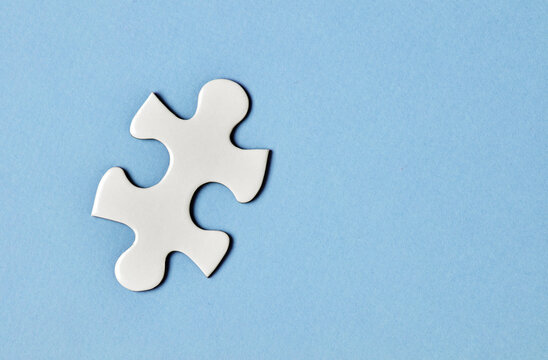 White puzzle piece on blue background