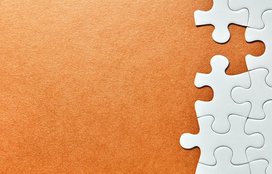 Puzzle pieces along right edge on orange background