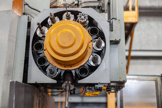 Close-up of industrial CNC machine tool changer with drills and milling cutters in factory. Modern industrial manufacturing, heavy machinery automation, mechanical components of complex hardware.