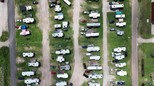 Overhead recreational layouts reveal aligned travel trailers beside Surfside Beach RV Park driveways. Grassy utility hookup lots host coastal travelers across Brazoria County, Texas