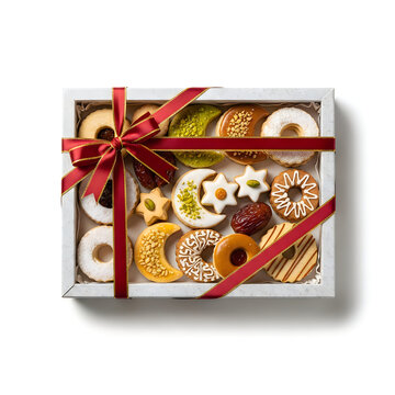A festive gift box filled with assorted christmas cookies and a red ribbon bow