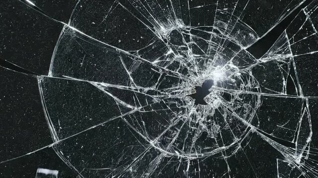 Dramatic glass fracture and shattered fragments isolated on black, capturing the moment of impact for advertising, promotional, and visual effects applications.