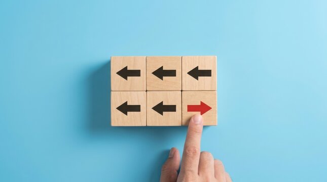 Hand placing a red arrow block against black arrows