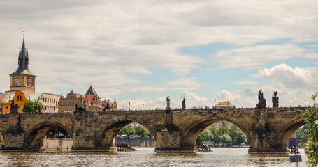 Fototapeta premium Charles Bridge in Prague, Czech Republic with historic towers and river view