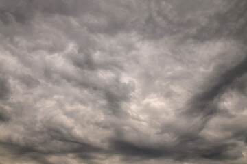 Fototapeta premium Dark dramatic storm clouds before thunderstorm with swirling sky texture