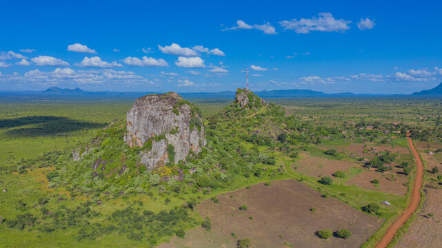 Aerial view of the rocky outcrops in Kidepo National Park with a dirt road winding through the savanna landscape in Kotido, Northern Region, Uganda.