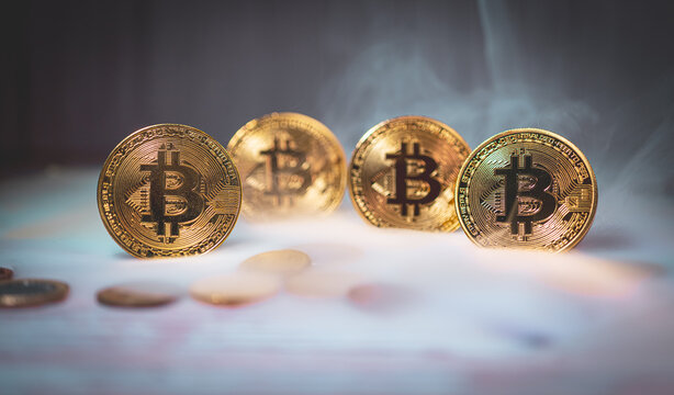 Multiple golden Bitcoin coins aligned in row symbolizing growth and diversification in digital assets.