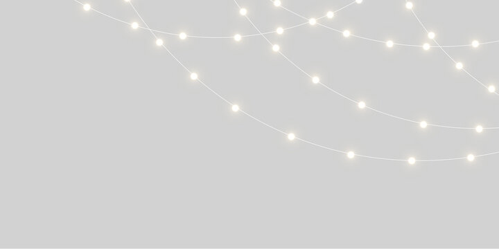 White glowing string lights hanging in curved rows across a neutral gray background with ample copy space.
