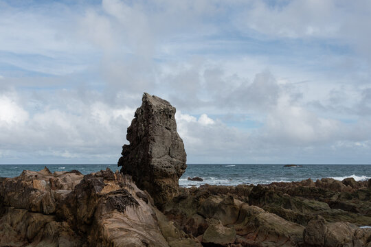 Giant Rock Formation Rising on Rocky Coast of Suzushima Island under Blue Sky in Shingu Wakayama