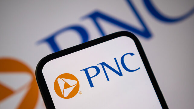PNC Bank logo displayed on smartphone screen with blurry brand name background.