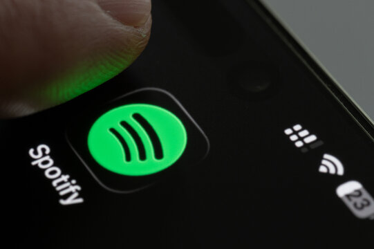 Finger press Spotify app icon