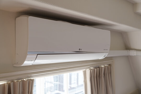 Amsterdam, Netherlands - August 12 2026: LG electronics wall-mounted air conditioner with exhaust duct installed in a residential building