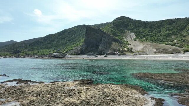 Aerial drone shot of Kumaya Cave on Iheya Island, Okinawa. A sacred power spot and legendary site of the Japanese 'Amano-Iwato' myth.
