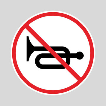 No horn traffic sign with a black horn symbol crossed by a red prohibition circle and diagonal slash.