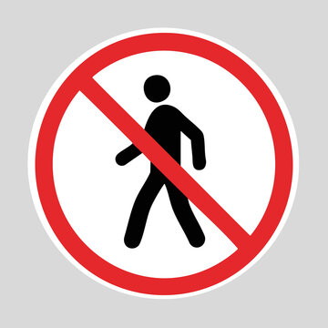 No walking prohibition sign with a pedestrian silhouette crossed out by a red circle and diagonal slash.
