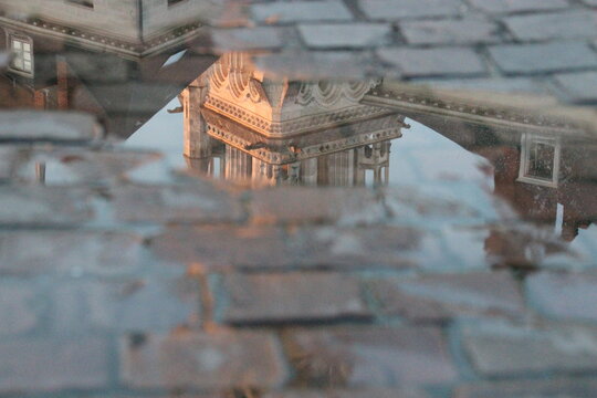 reflection of a church (st nicolas basilica) in a puddle in nantes in france 