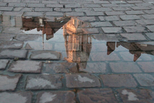reflection of a church (st nicolas basilica) in a puddle in nantes in france 