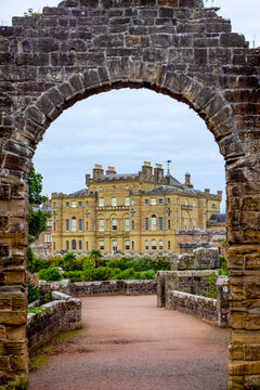 The historic cliff-top Culzean Castle overlooking the Firth of Clyde seen through an arch